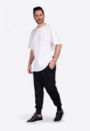 Model wearing oversized white monogram T-shirt for elevated everyday comfort East Vibe